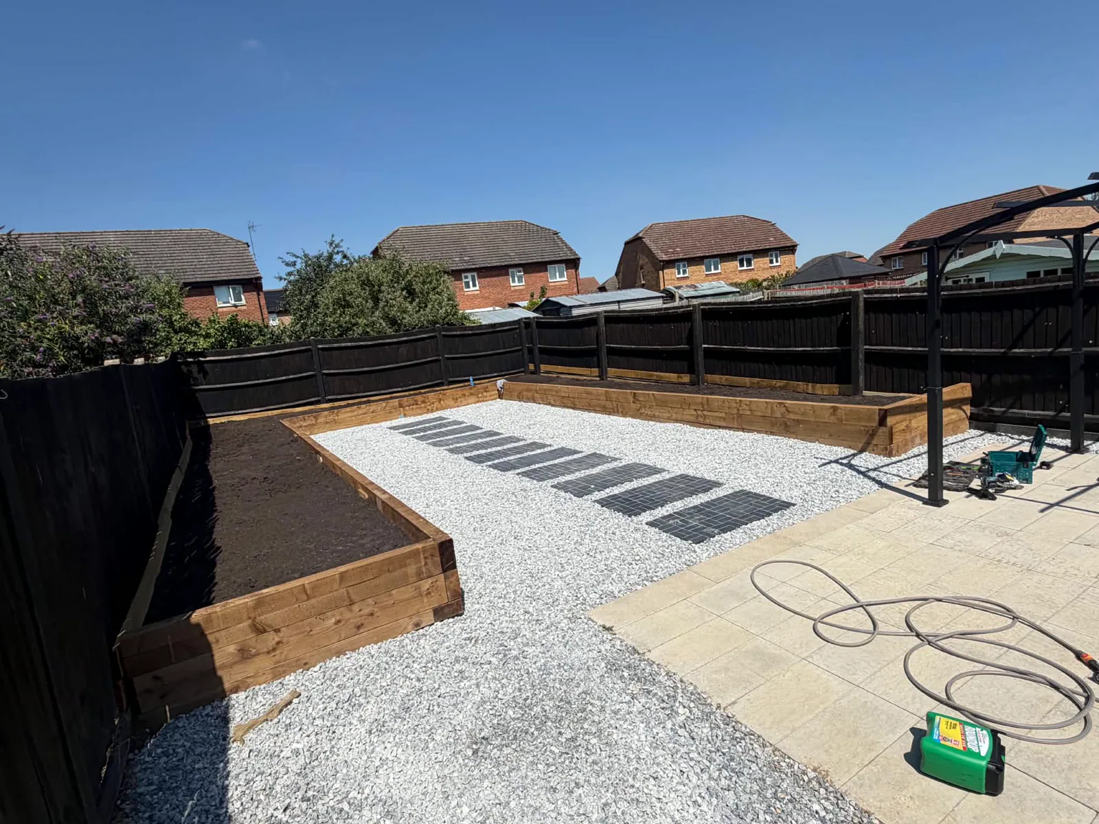 Landscaped garden with gravel, paving and raised timber beds