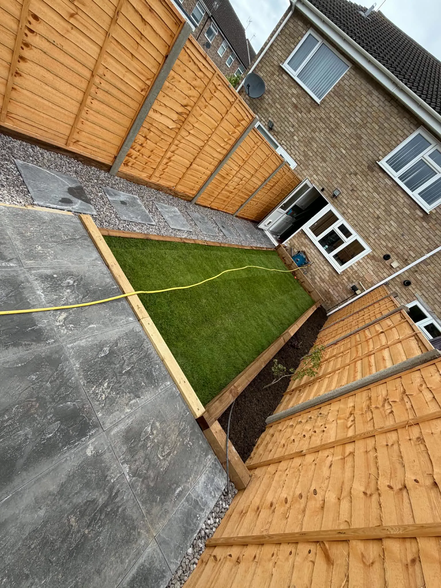 Finished garden landscaping with turf and paved seating area