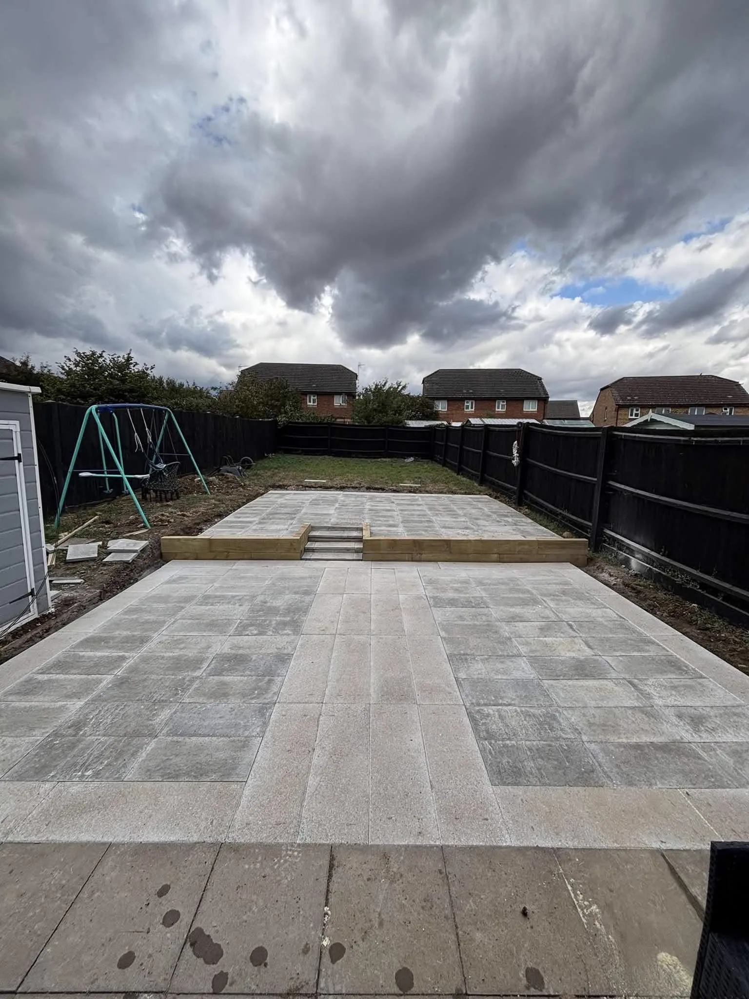 The same garden after a large two-level patio was installed