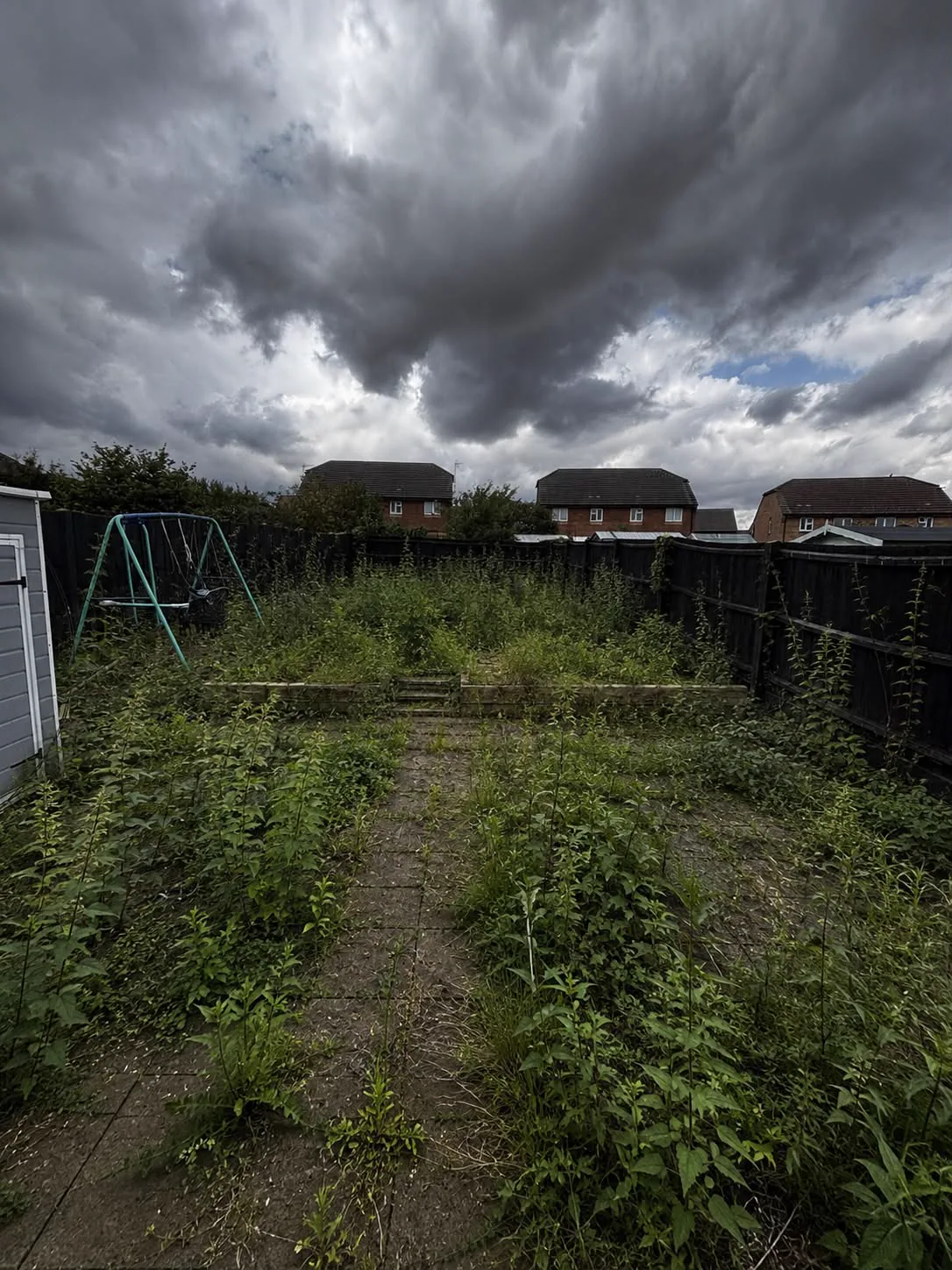 Large overgrown garden before clearance and patio installation